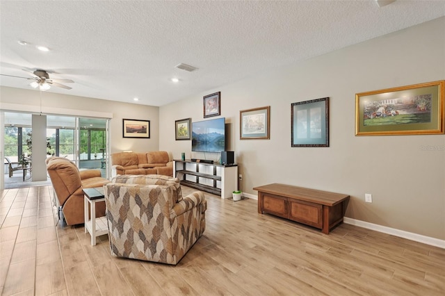 49 White Horse Way, Groveland, FL 34736 - living room featuring a textured ceiling, a ceiling fan, light wood finished floors, and recessed lighting