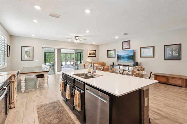 49 White Horse Way, Groveland, FL 34736 - kitchen featuring stainless steel dishwasher, open floor plan, light countertops, a kitchen island with sink, and recessed lighting