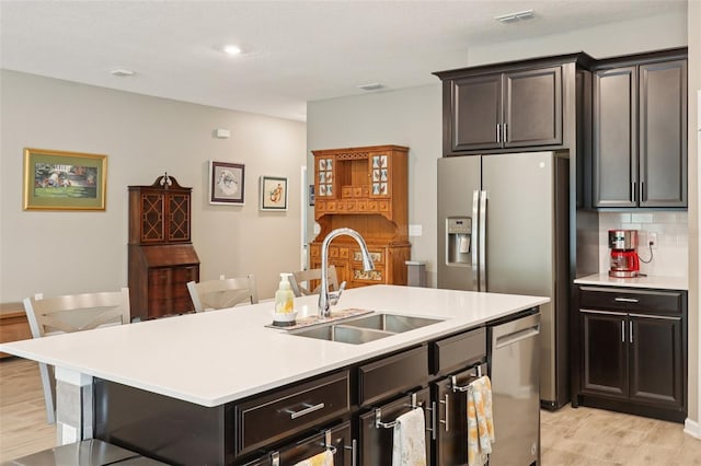 49 White Horse Way, Groveland, FL 34736 - kitchen featuring stainless steel dishwasher, light countertops, decorative backsplash, a center island with sink, and recessed lighting