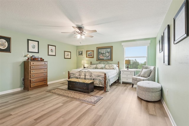 49 White Horse Way, Groveland, FL 34736 - bedroom featuring light wood-type flooring, a textured ceiling, and a ceiling fan