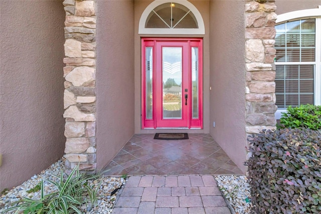 18139 Great Blue Heron Dr, Groveland, FL 34736 - doorway to property with stone siding and stucco siding