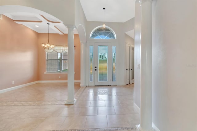 18139 Great Blue Heron Dr, Groveland, FL 34736 - foyer with ornate columns, a chandelier, arched walkways, and light tile patterned floors