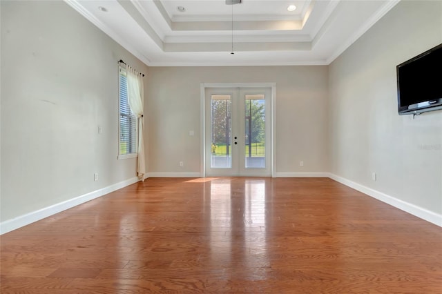 18139 Great Blue Heron Dr, Groveland, FL 34736 - unfurnished room featuring wood finished floors, french doors, a tray ceiling, and ornamental molding