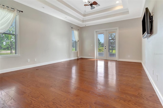 18139 Great Blue Heron Dr, Groveland, FL 34736 - spare room with plenty of natural light, wood finished floors, crown molding, and a tray ceiling