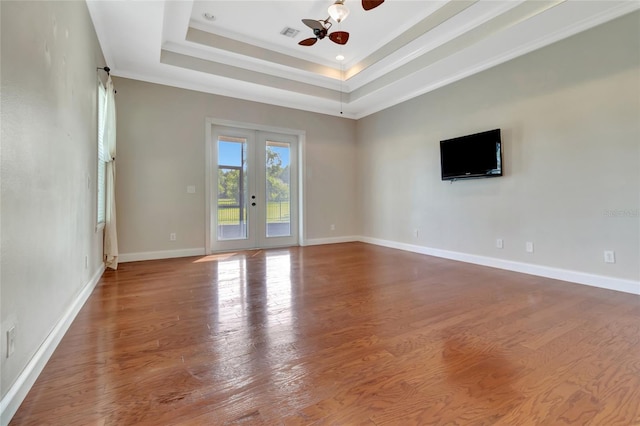 18139 Great Blue Heron Dr, Groveland, FL 34736 - unfurnished room with wood finished floors, a tray ceiling, a ceiling fan, and crown molding
