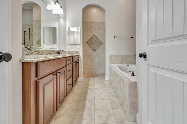 18139 Great Blue Heron Dr, Groveland, FL 34736 - bathroom featuring double vanity, a bath, tile patterned flooring, and walk in shower