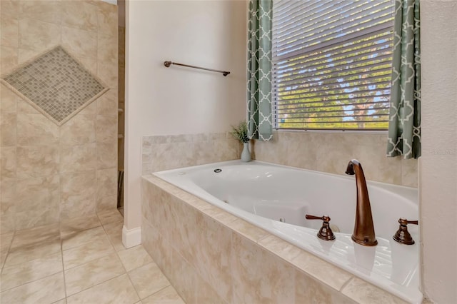 18139 Great Blue Heron Dr, Groveland, FL 34736 - full bath featuring tile patterned floors, a tub with jets, and tiled shower
