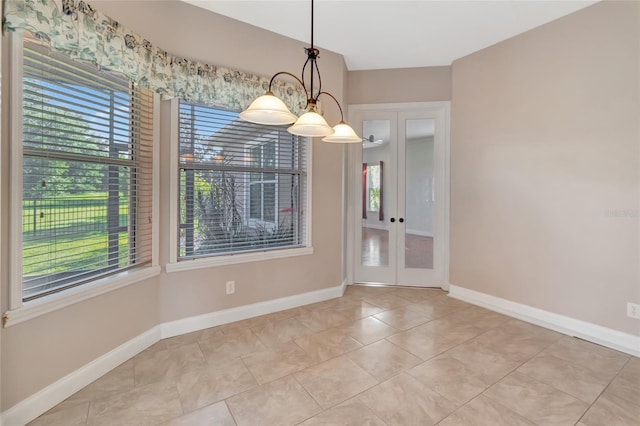 18139 Great Blue Heron Dr, Groveland, FL 34736 - unfurnished dining area with french doors, tile patterned flooring, and a chandelier