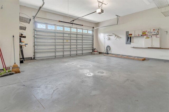 18139 Great Blue Heron Dr, Groveland, FL 34736 - garage featuring a garage door opener and electric panel