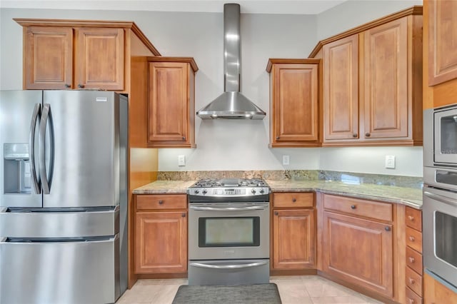 18139 Great Blue Heron Dr, Groveland, FL 34736 - kitchen featuring stainless steel appliances, wall chimney exhaust hood, and brown cabinetry