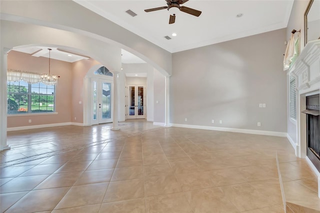 18139 Great Blue Heron Dr, Groveland, FL 34736 - unfurnished living room with arched walkways, ceiling fan, a chandelier, a fireplace, and light tile patterned floors