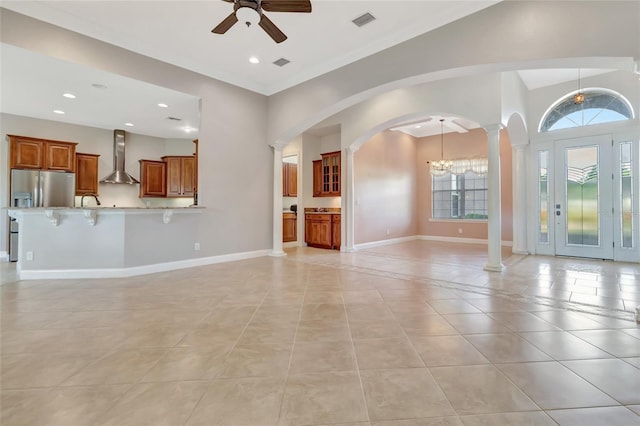 18139 Great Blue Heron Dr, Groveland, FL 34736 - unfurnished living room featuring decorative columns, a ceiling fan, arched walkways, light tile patterned floors, and recessed lighting