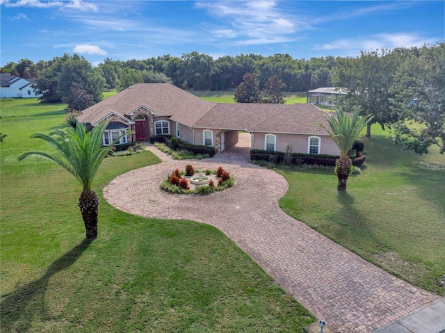 18139 Great Blue Heron Dr, Groveland, FL 34736 - single story home featuring curved driveway, a front lawn, and stucco siding