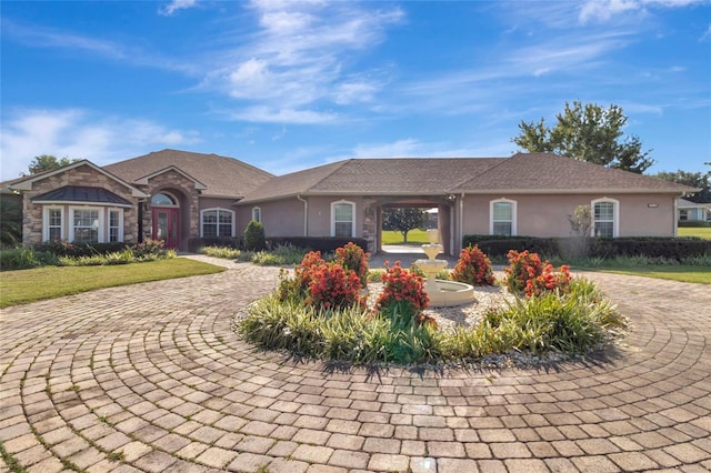 18139 Great Blue Heron Dr, Groveland, FL 34736 - single story home with stucco siding, curved driveway, and stone siding