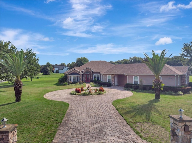 18139 Great Blue Heron Dr, Groveland, FL 34736 - ranch-style home with curved driveway and a front yard