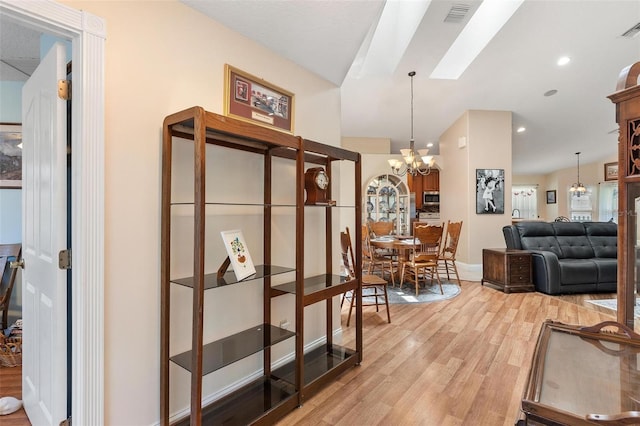 1412 Cove Pl, Tavares, FL 32778 - dining space with light wood finished floors, vaulted ceiling, and a chandelier