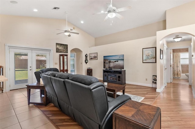 1412 Cove Pl, Tavares, FL 32778 - living area featuring arched walkways, ceiling fan, french doors, light wood-style flooring, and high vaulted ceiling