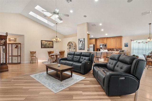 1412 Cove Pl, Tavares, FL 32778 - living room featuring a chandelier, ceiling fan, a skylight, light wood-style floors, and recessed lighting