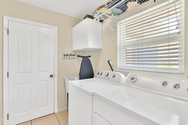 1412 Cove Pl, Tavares, FL 32778 - washroom with cabinet space, washing machine and dryer, and light tile patterned flooring