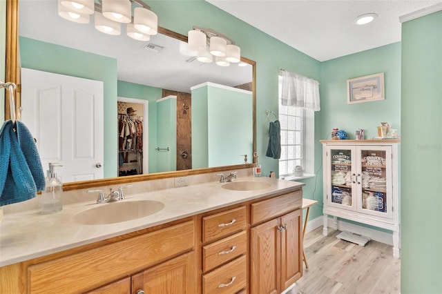 1412 Cove Pl, Tavares, FL 32778 - full bath with double vanity, wood finished floors, a tile shower, and a spacious closet