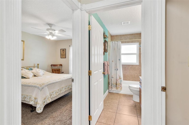 1412 Cove Pl, Tavares, FL 32778 - bedroom with a textured ceiling, light tile patterned floors, ensuite bath, and a ceiling fan