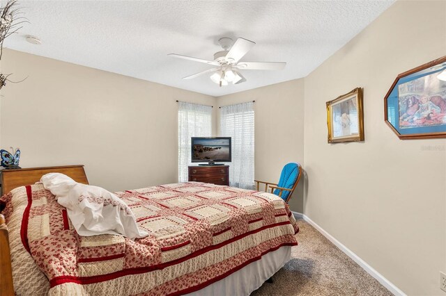 1412 Cove Pl, Tavares, FL 32778 - carpeted bedroom featuring a textured ceiling and ceiling fan
