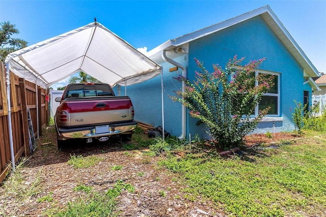 1412 Cove Pl, Tavares, FL 32778 - view of side of property with a carport and stucco siding