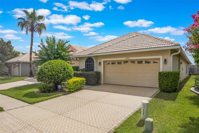 9015 Saint Andrews Way, Mount Dora, FL 32757 - ranch-style house featuring an attached garage, stucco siding, driveway, and a front lawn