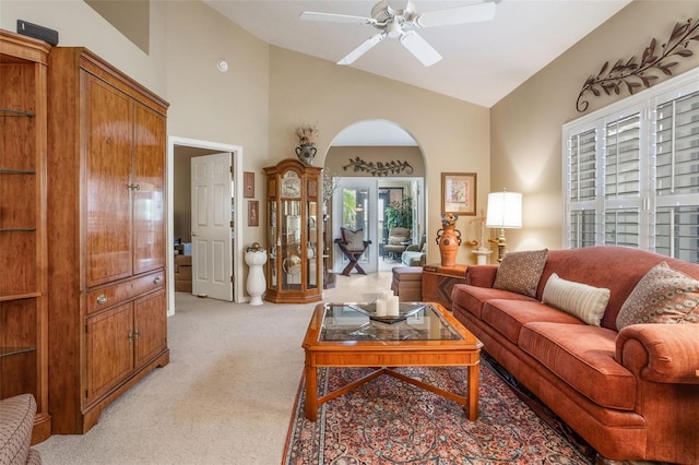 9015 Saint Andrews Way, Mount Dora, FL 32757 - living room with light carpet, arched walkways, ceiling fan, high vaulted ceiling, and french doors