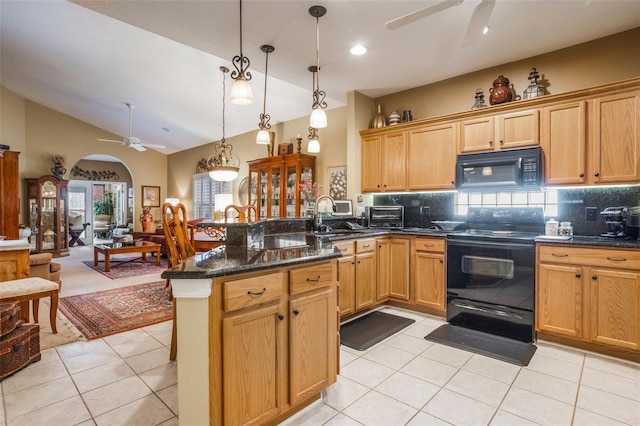 9015 Saint Andrews Way, Mount Dora, FL 32757 - kitchen with black appliances, ceiling fan, a peninsula, light tile patterned flooring, and tasteful backsplash
