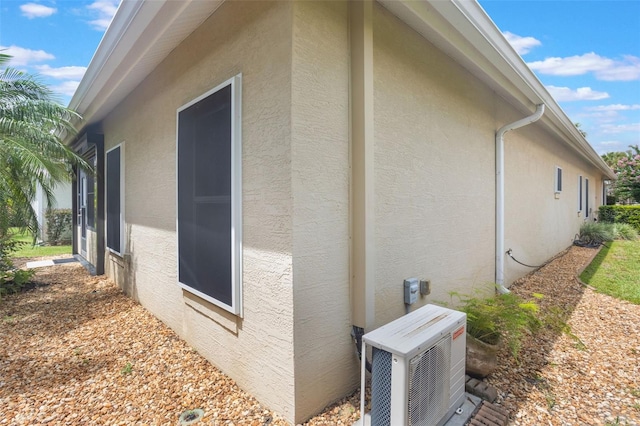 9015 Saint Andrews Way, Mount Dora, FL 32757 - view of property exterior with an ac unit and stucco siding