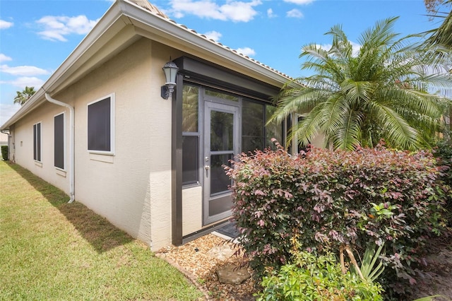 9015 Saint Andrews Way, Mount Dora, FL 32757 - view of side of home with stucco siding and a lawn