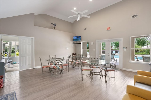 9015 Saint Andrews Way, Mount Dora, FL 32757 - dining area featuring high vaulted ceiling, french doors, a ceiling fan, and light wood-style floors