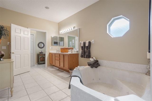 9015 Saint Andrews Way, Mount Dora, FL 32757 - bathroom with double vanity, tile patterned flooring, and a jetted tub