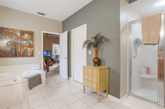 9015 Saint Andrews Way, Mount Dora, FL 32757 - full bath featuring a stall shower, a garden tub, and tile patterned floors