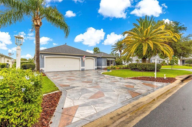 89 Palermo Pl, The Villages, FL 32159 - ranch-style home featuring an attached garage, driveway, a front lawn, and stucco siding
