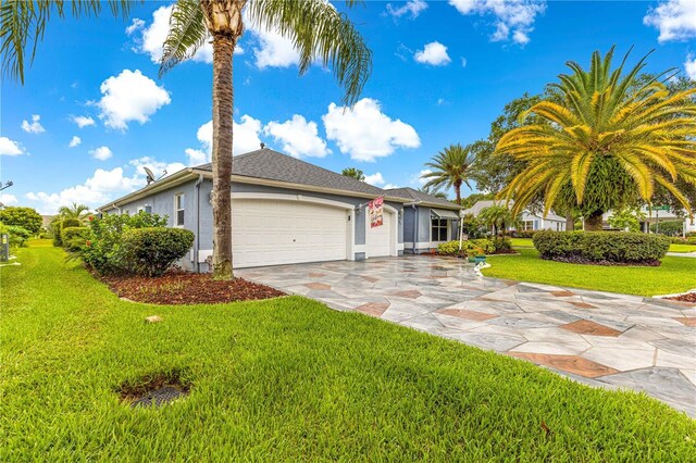 89 Palermo Pl, The Villages, FL 32159 - view of front of house featuring a garage, stucco siding, concrete driveway, and a front lawn