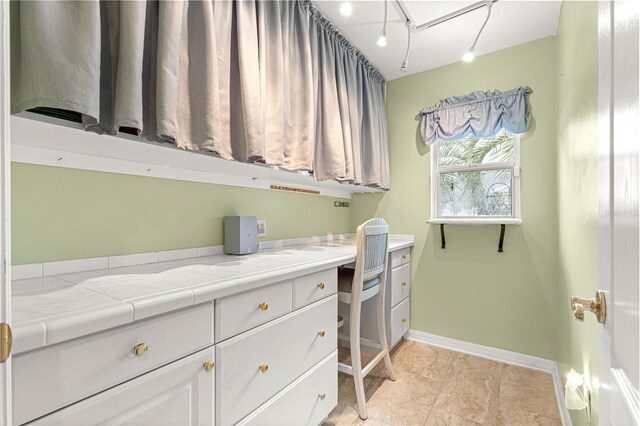 89 Palermo Pl, The Villages, FL 32159 - laundry area with baseboards and a desk