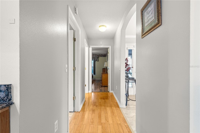 89 Palermo Pl, The Villages, FL 32159 - hallway with arched walkways and light wood finished floors
