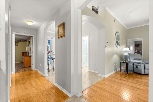 89 Palermo Pl, The Villages, FL 32159 - hallway featuring arched walkways, light wood-type flooring, and ornamental molding