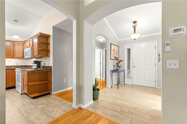 89 Palermo Pl, The Villages, FL 32159 - kitchen featuring open shelves, vaulted ceiling, white appliances, arched walkways, and ornamental molding