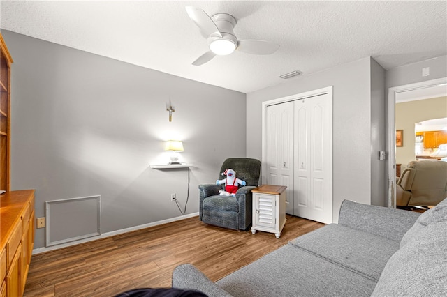 89 Palermo Pl, The Villages, FL 32159 - living room with wood finished floors, ceiling fan, and a textured ceiling