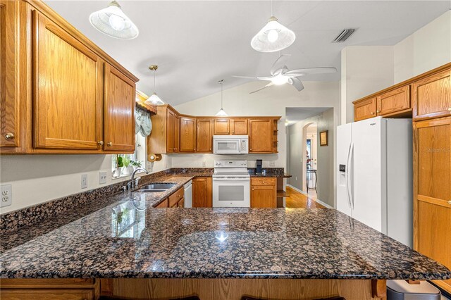 89 Palermo Pl, The Villages, FL 32159 - kitchen with white appliances, a peninsula, ceiling fan, brown cabinetry, and lofted ceiling