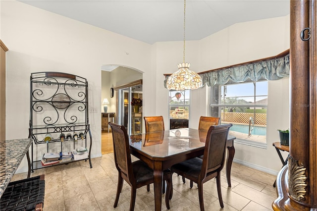 89 Palermo Pl, The Villages, FL 32159 - dining space with arched walkways, light tile patterned floors, and lofted ceiling