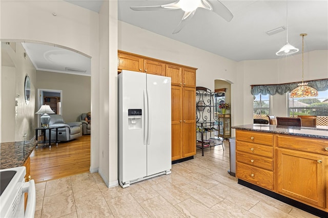 89 Palermo Pl, The Villages, FL 32159 - kitchen with white refrigerator with ice dispenser, arched walkways, stove, a ceiling fan, and brown cabinetry