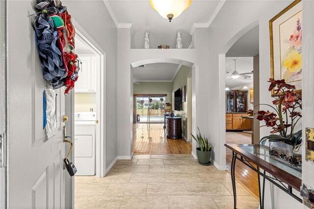89 Palermo Pl, The Villages, FL 32159 - foyer entrance featuring washer / dryer, crown molding, arched walkways, and ceiling fan