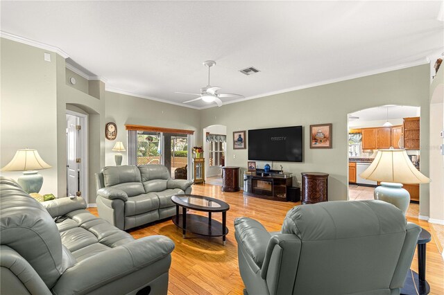 89 Palermo Pl, The Villages, FL 32159 - living room featuring arched walkways, crown molding, ceiling fan, and light wood-type flooring