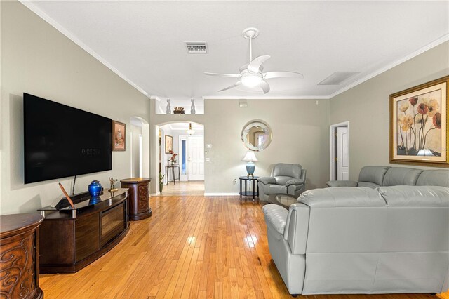 89 Palermo Pl, The Villages, FL 32159 - living room with arched walkways, ornamental molding, a ceiling fan, and light wood finished floors