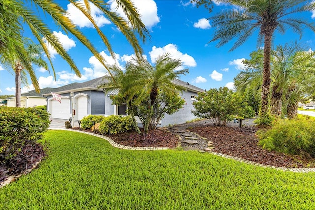 89 Palermo Pl, The Villages, FL 32159 - view of home's exterior with stucco siding, a garage, and a lawn