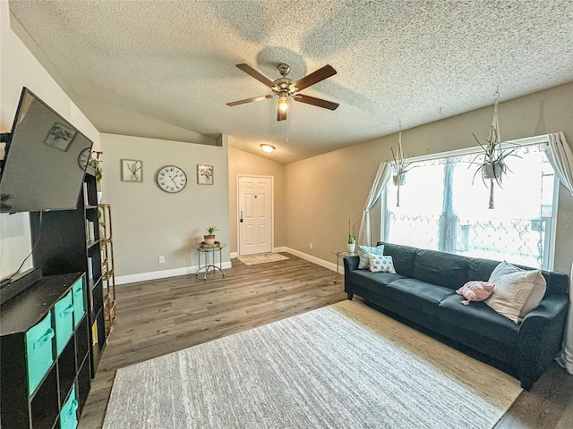7047 Hickory Branch Cir, Orlando, FL 32818 - living area with wood finished floors, a ceiling fan, a textured ceiling, and lofted ceiling